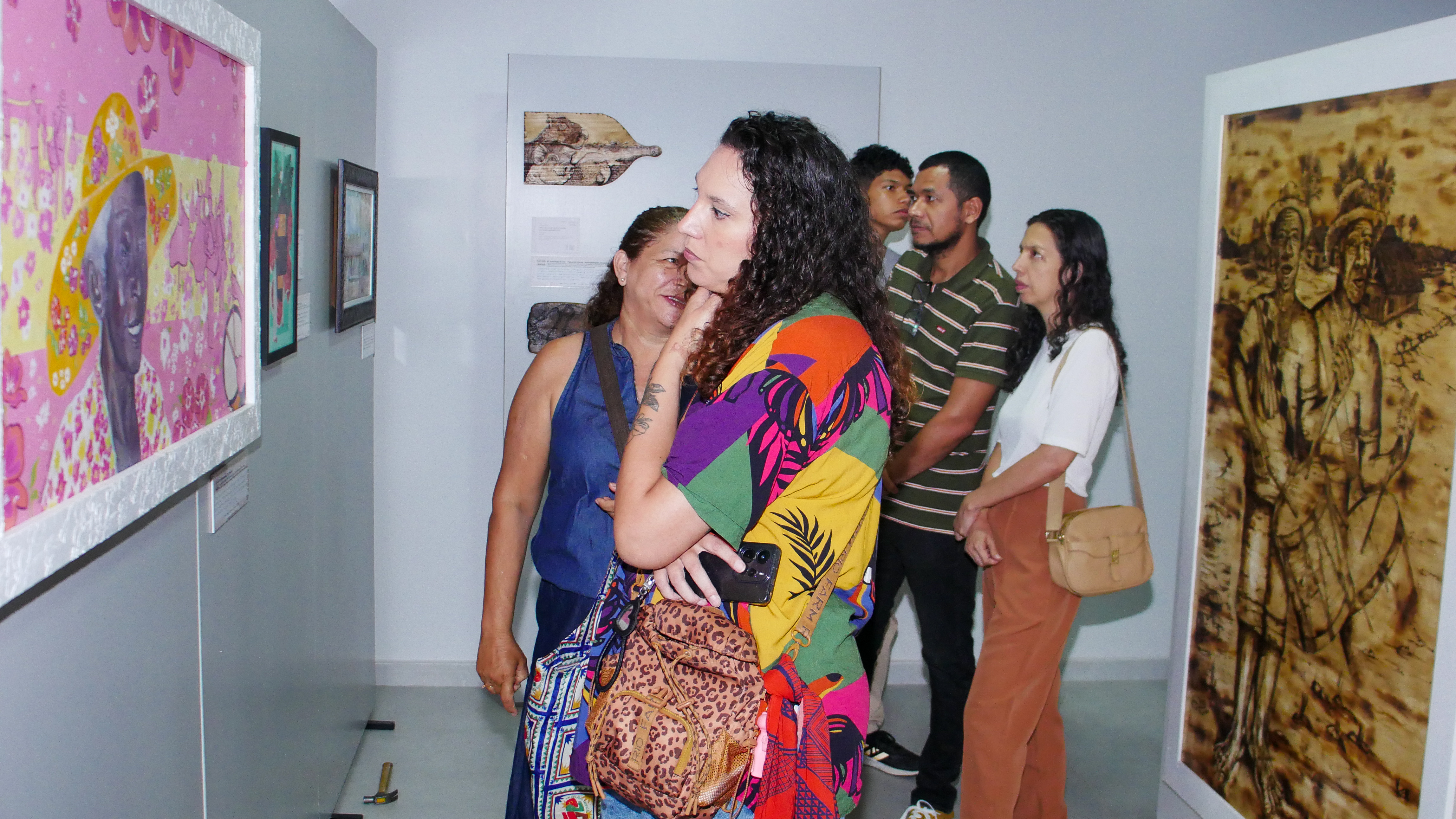 Exposição Além dos Verdes — visitantes observando obra